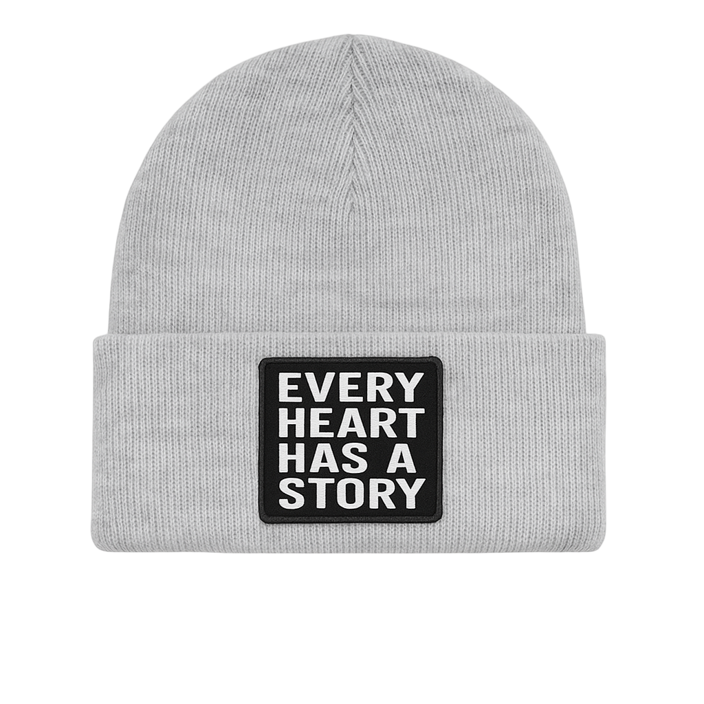 Gray beanie with a patch that says 'Every Heart Has a Story' on a white background