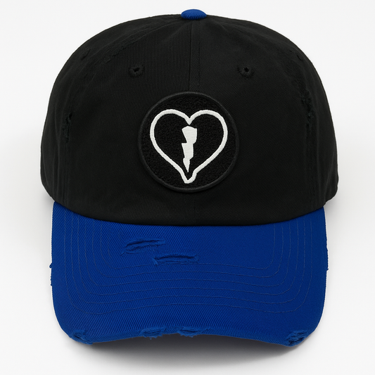 Distressed black and royal blue cap featuring the official Liveblackheart chenille heart and lightning bolt logo, lifestyle streetwear brand Every Heart Has A Story.