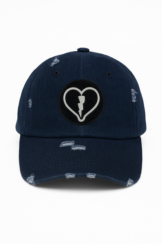 Distressed dark denim cap featuring the official Liveblackheart chenille heart and lightning bolt logo, lifestyle streetwear brand Every Heart Has A Story.