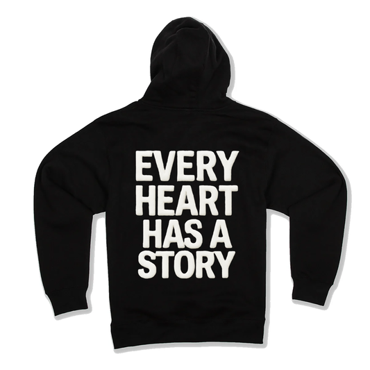 Black hoodie with 'Every Heart Has a Story' text on the back against a white background