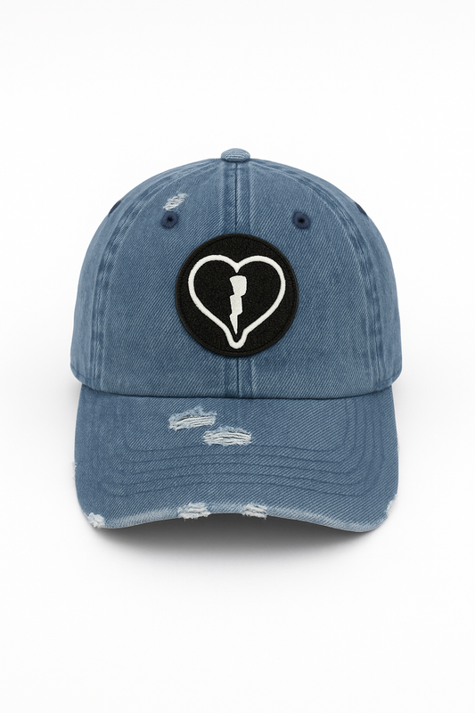 Distressed light denim cap featuring the official Liveblackheart chenille heart and lightning bolt logo, lifestyle streetwear brand Every Heart Has A Story.